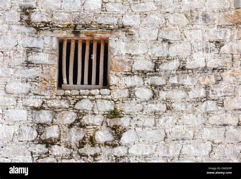 Old prison cell window with wooden bars in a white brick wall Stock ...