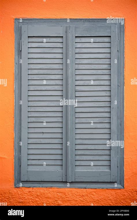Orange wall with vintage window blinds Stock Photo - Alamy