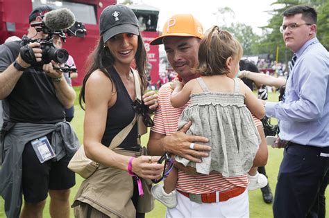 Rickie Fowler embraces wife Allison Stokke after Rocket Mortgage Classic