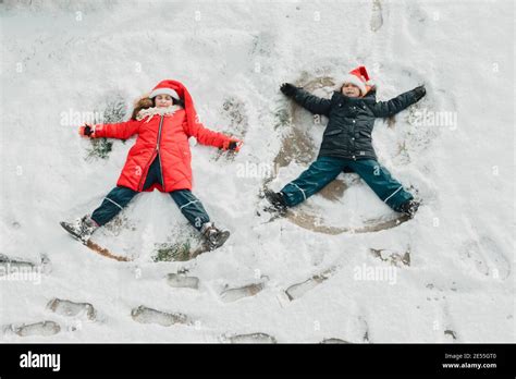 the cute little kids make snow angel on the ground Stock Photo - Alamy