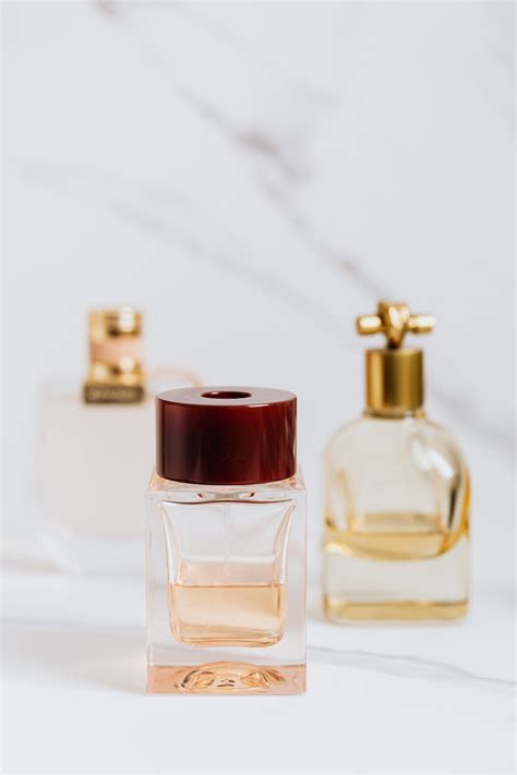 Clear Glass Perfume Bottle on White Table · Free Stock Photo