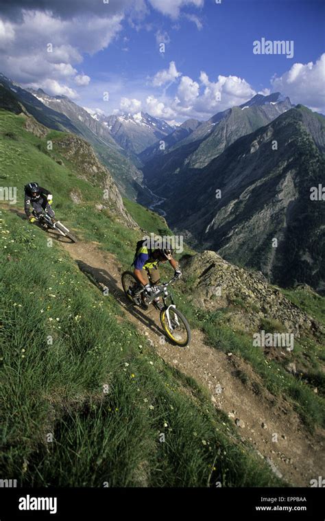 Men mountain biking on the trail in Les 2 Alpes Stock Photo - Alamy