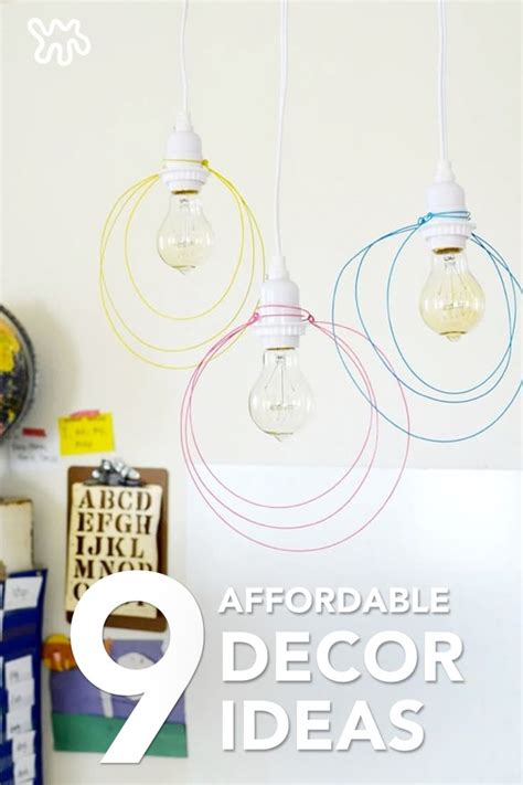 three light bulbs hanging from the ceiling in a room with pictures on ...