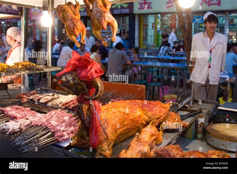 Roasted lamb and chicken at the night market in Urumqi in Xinjiang province in China Stock Photo ...