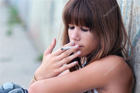 Teenage girl smoking cigarette — Stock Photo © SolidPhotos #60723527