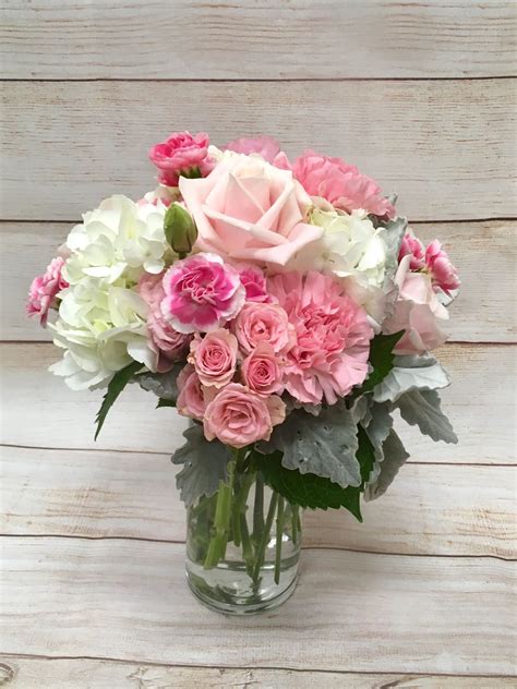 Pretty n pink centerpiece made of hydrangea, roses and mini carnations. | Pink centerpieces ...