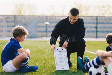 Young Soccer Trainer Coach Explaining Tactic on Team Sports Tactics Board Stock Photo - Image of ...