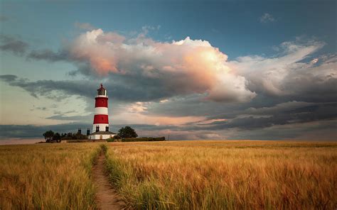 Evening light over Happisburgh Lighthouse Photograph by David Powley | Fine Art America