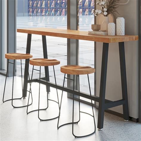 four stools are sitting at the bar in front of an open window with ...