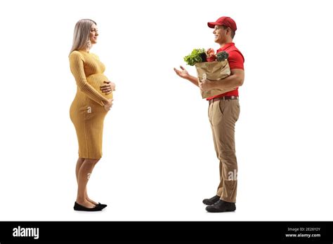 Full length profile shot of a pregnant woman and a store delivery man with groceries isolated on ...