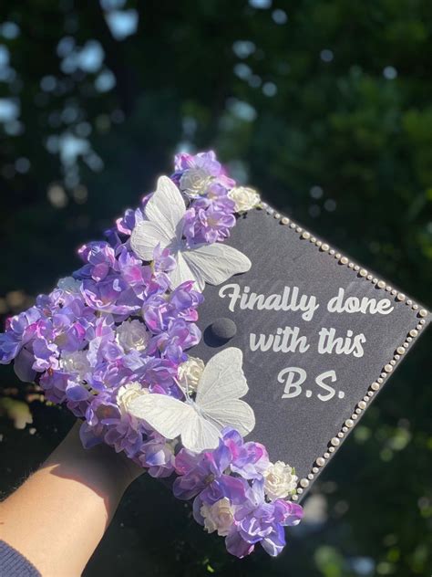 graduation cap design with purple & white flowers, white butterflies ...