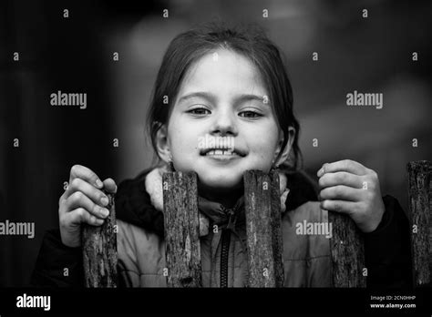 Little girl standing behind wall Black and White Stock Photos & Images ...
