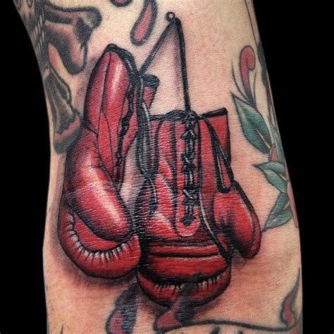 a tattoo with two boxing gloves on it