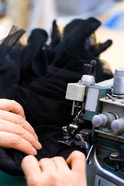 Premium Photo | Hands work a sewing machine.