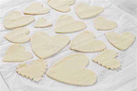 Cut Out Hearts of Various Shapes and Sizes from Raw Dough on White Parchment. Stock Image ...