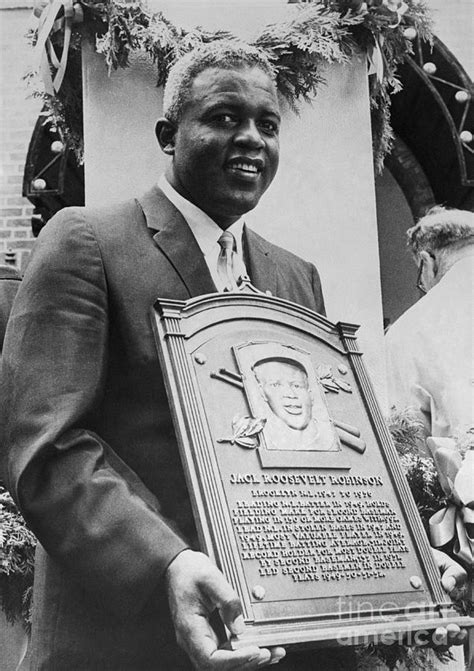 Jackie Robinson Holding Plaque At Hall by Bettmann