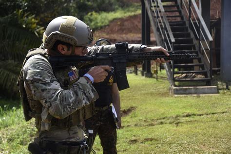 A U.S. Army Green Beret steadies his weapon before firing at targets on ...