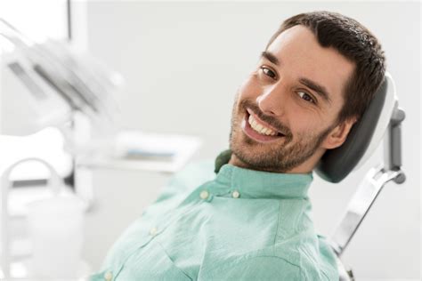 happy smiling male patient at dental clinic - Stovall & Cheng DDS, PLLC