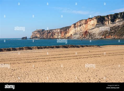 beach with cliff in Nazare, Portugal Stock Photo - Alamy