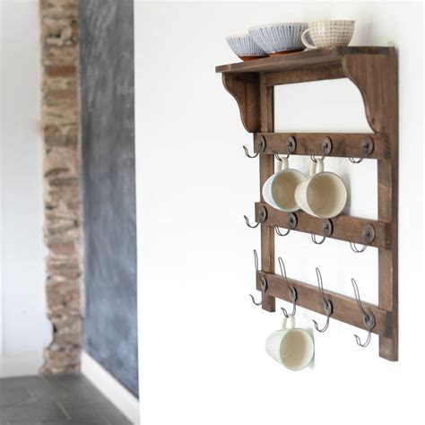 wooden wall shelf with hooks by the forest & co | notonthehighstreet.com