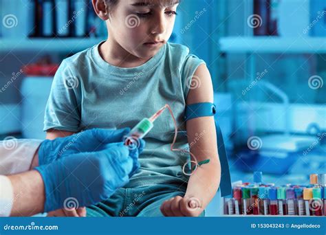 Technician Making Blood Tests on a Young Boy in the Laboratory of Blood ...