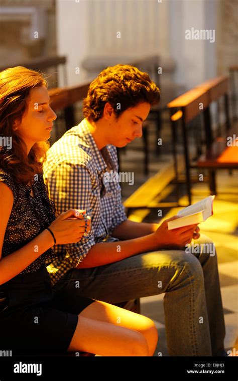 Teenagers praying and reading the Bible in a church Stock Photo - Alamy