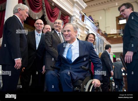 Texas Gov. Greg Abbott rolls his wheelchair down ramp from dais in the ...