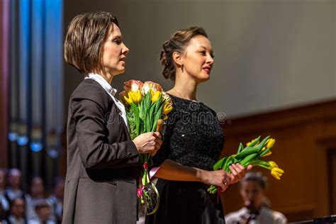 Women Choir and Orchestra Conductors with Flowers on Stage. Editorial Stock Photo - Image of ...