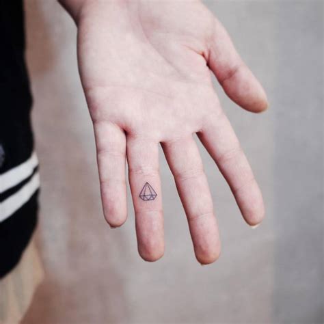 Fine line diamond tattoo on the finger