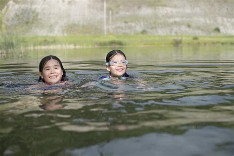 Kids Swimming In Lake