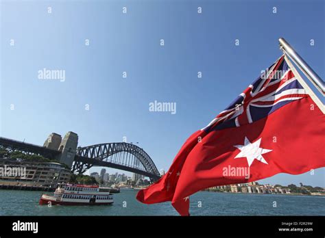 The Australian Red Ensign flag blowing in the wind against the Sydney ...