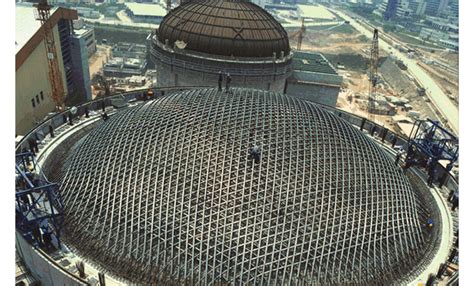 an aerial view of a large dome structure under construction in the middle of a city