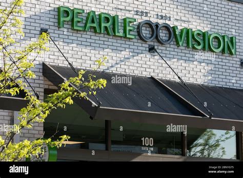 A logo sign outside of a Pearle Vision retail store location in King of ...