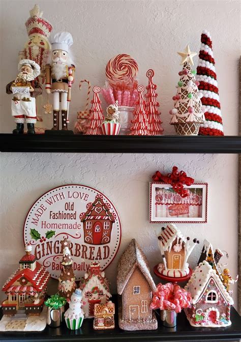 two black shelves filled with christmas decorations and gingerbread ...