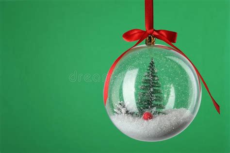 Beautiful Christmas Snow Globe Hanging on Green Background, Closeup. Space for Text Stock Photo ...