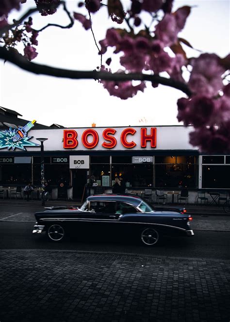 Online crop | HD wallpaper: Bosch LED signage, black coupe beside Bosch store, building, car ...