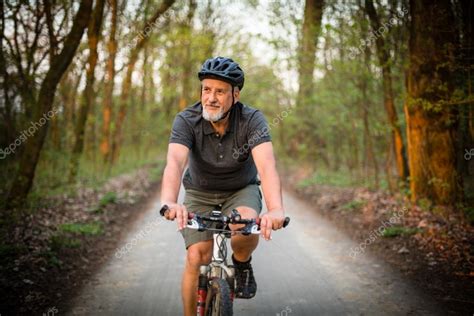 Senior man on his mountain bike outdoors — Stock Photo © lightpoet ...