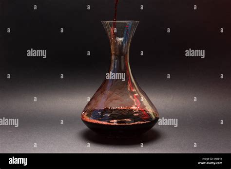 Decanting red wine Stock Photo - Alamy