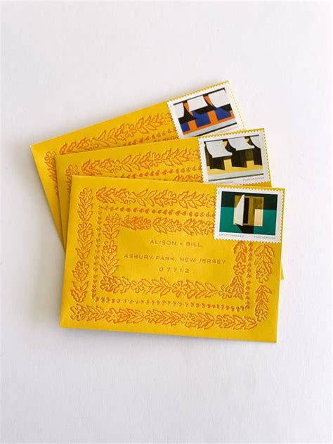 Yellow envelopes with modern artistic stamps with letterpress printing around the boarders ...