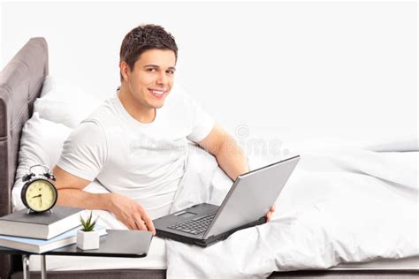 Man Lying On A Bed And Working On A Laptop Stock Image - Image of laptop, home: 25646041