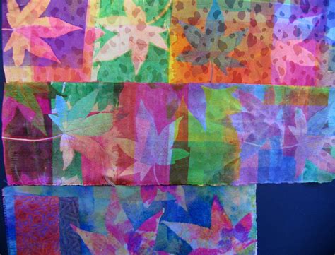 an art project made with colored paper and fabric, featuring leaves on different colors in the ...