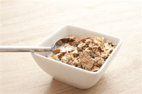bowl with cereal on wood table - Free Stock Image