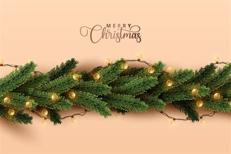 Shiny christmas lights wrapped in realistic pine tree leaves on soft orange background. Merry ...