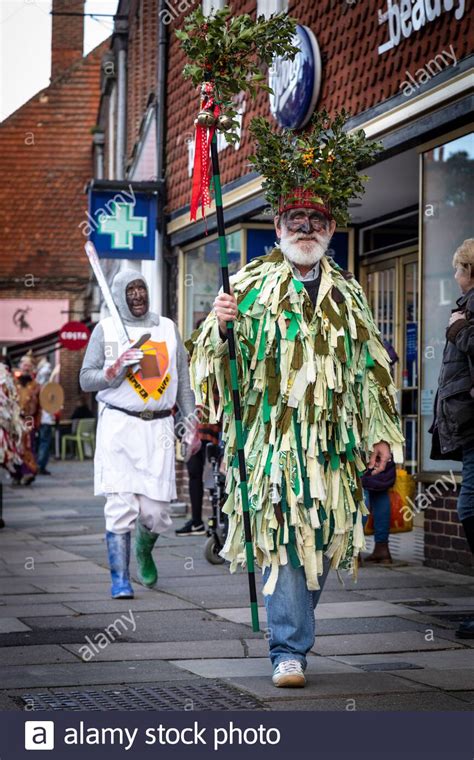 Mummers dressed in traditional costume make there way along Haslemere High Street prior to their ...