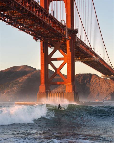 Fort Point view of Golden Gate Bridge & Surfer | Explorest