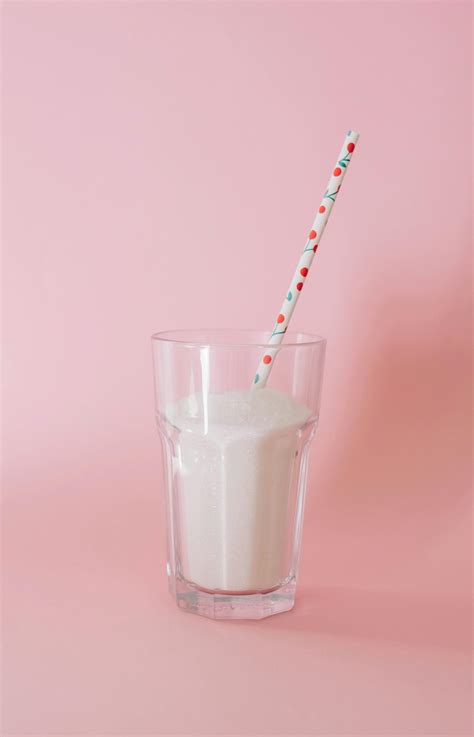 Woman Pulling Straw out of Glass of Thick Milk Tea · Free Stock Photo