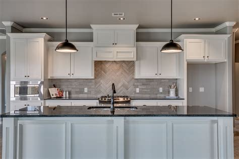 I love the limestone backsplash in herringbone pattern. | Backsplash, Kitchen cabinets ...