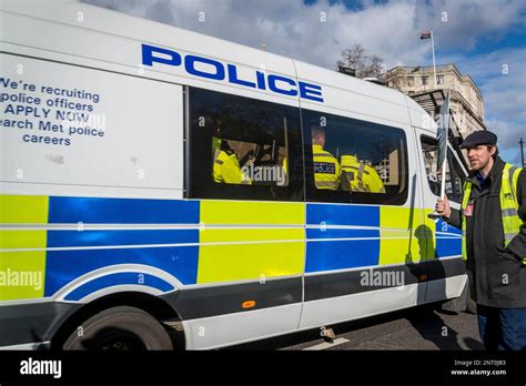 Police van with police officers inside and a lone protestor with a ...