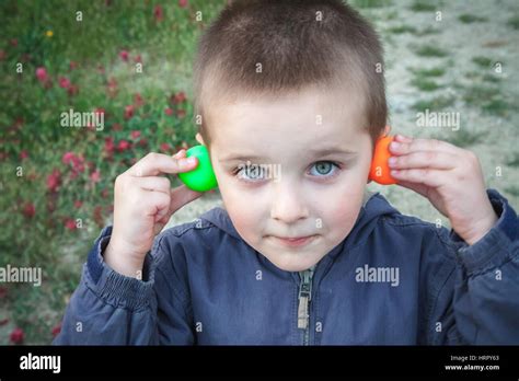 Kid playing with colored ping pong ball making faces Stock Photo - Alamy
