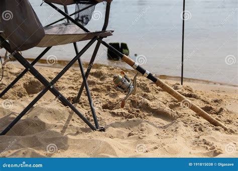 Folding Chair and Fishing Rod Stand at the Beach. Fishing Singly Stock ...